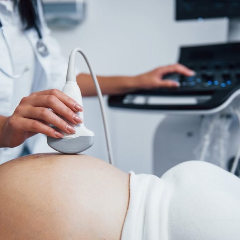 Female doctor does ultrasound for a pregnant woman in the hospital.